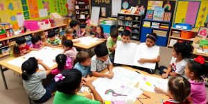 Students engaging in creative storytelling in a colorful classroom.